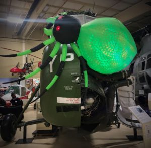 Inflatable spider on the windscreen of a large green military helicopter